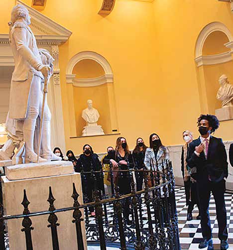 Students looking up at a statue in the capitol rotunda