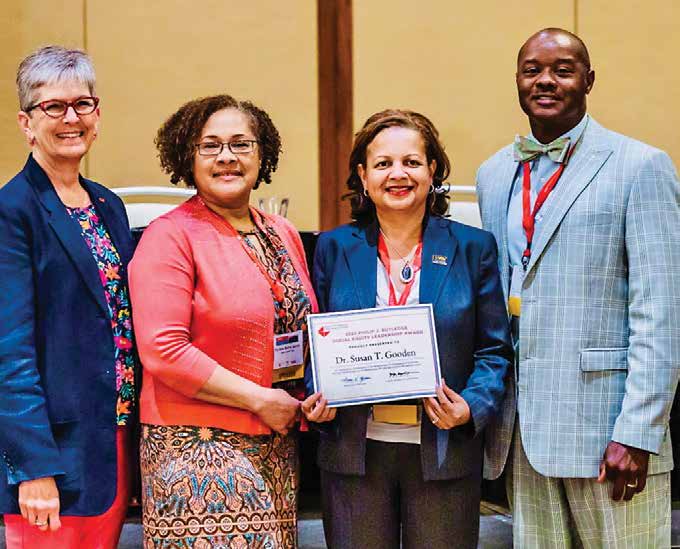 Susan gooden standing with three others to receive her award