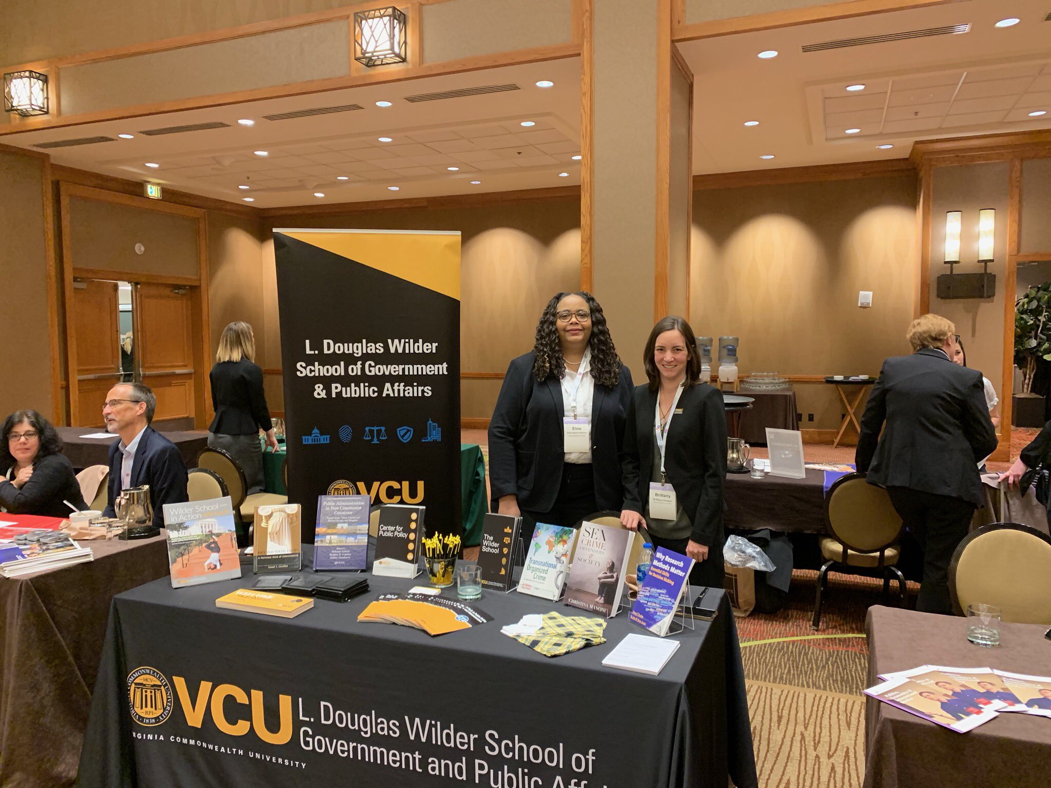 Wilder School faculty members Elsie Harper-Anderson and Brittany Keegan staff the table at the APPAM Doctoral Student Fair on November 9, 2019. 