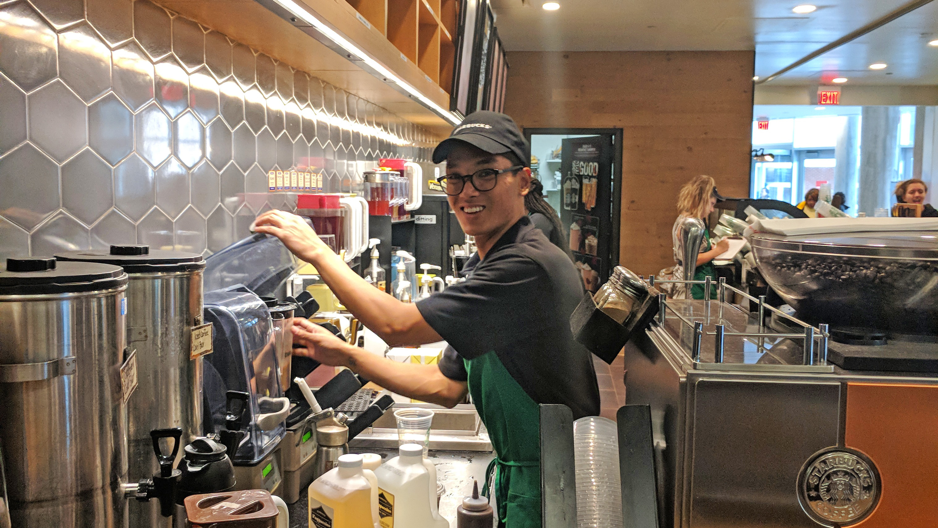 Zach Villegas, a criminal justice and homeland security and emergency preparedness double major, manages customer orders at his part-time job at the Cabell Library Starbucks Coffee.