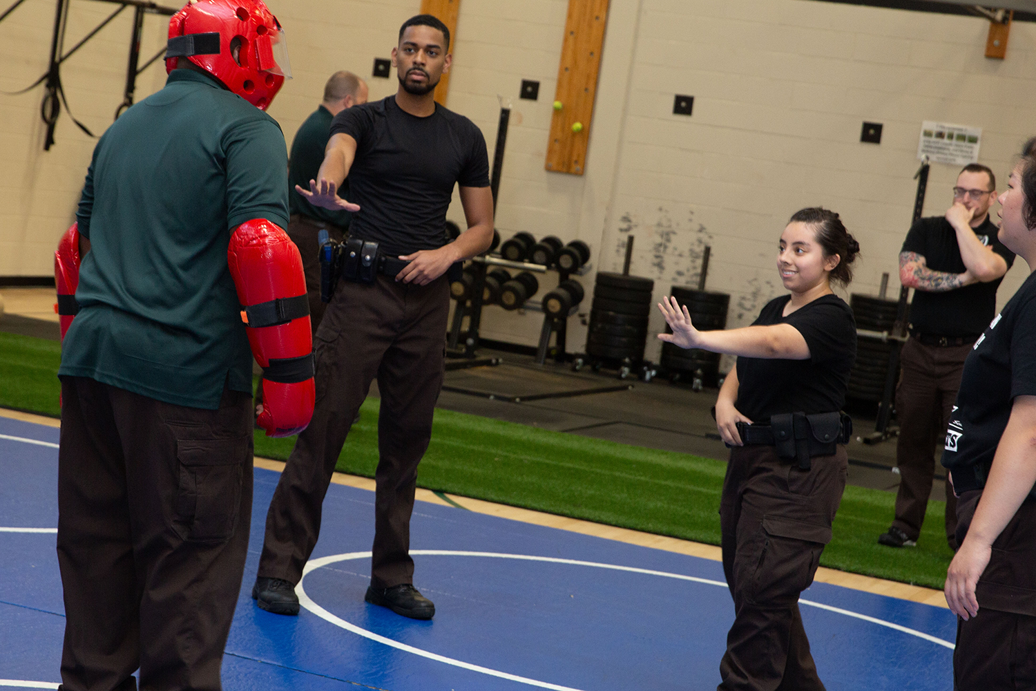Melani Monje Riberth (with arm outstretched) participates in a scenario drill at the Basic Summer Jailors Academy.