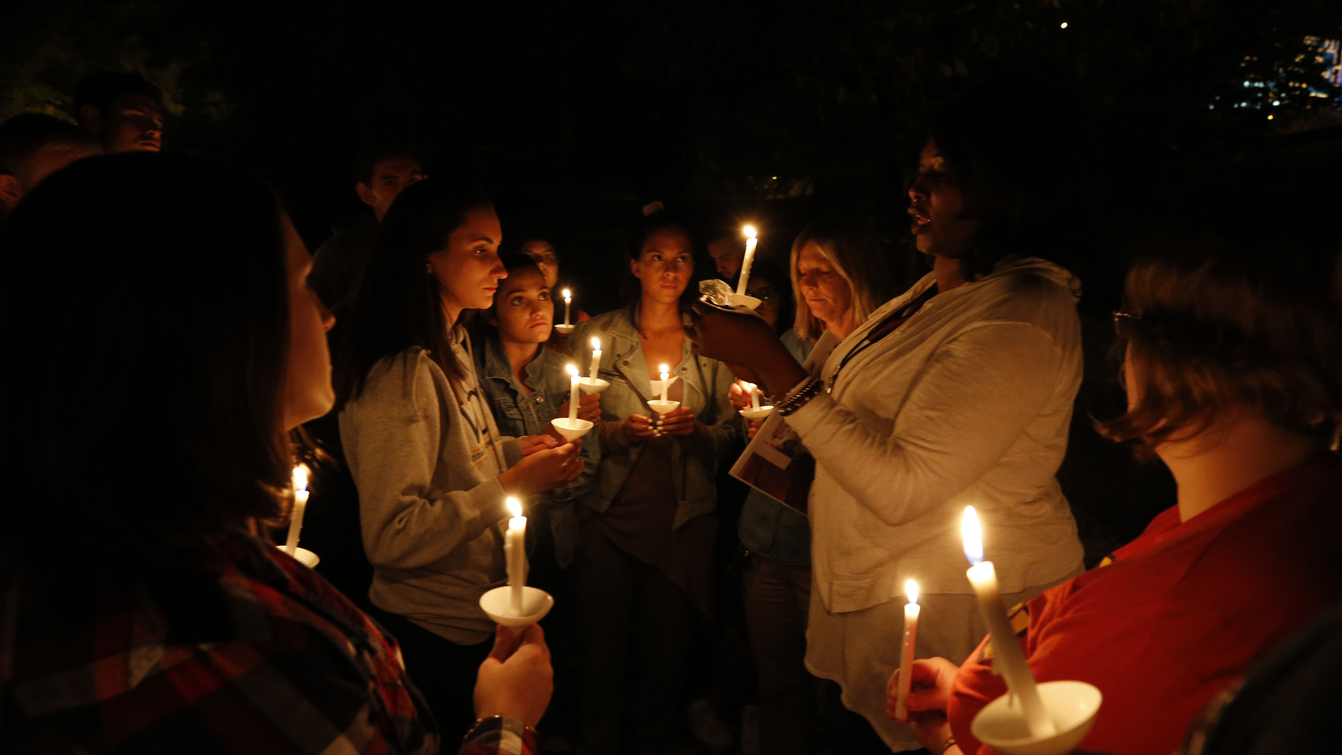 Free Egunfemi, director of Untold RVA, leads Wilder School students in a candle lighting ceremony to honor the lives of the enslaved at Richmond's African Ancestral Burial Grounds on Sept. 7. The students are members of HSEP: 391: Human Trafficking, a course led by assistant professor Maureen Moslow-Benway. 
