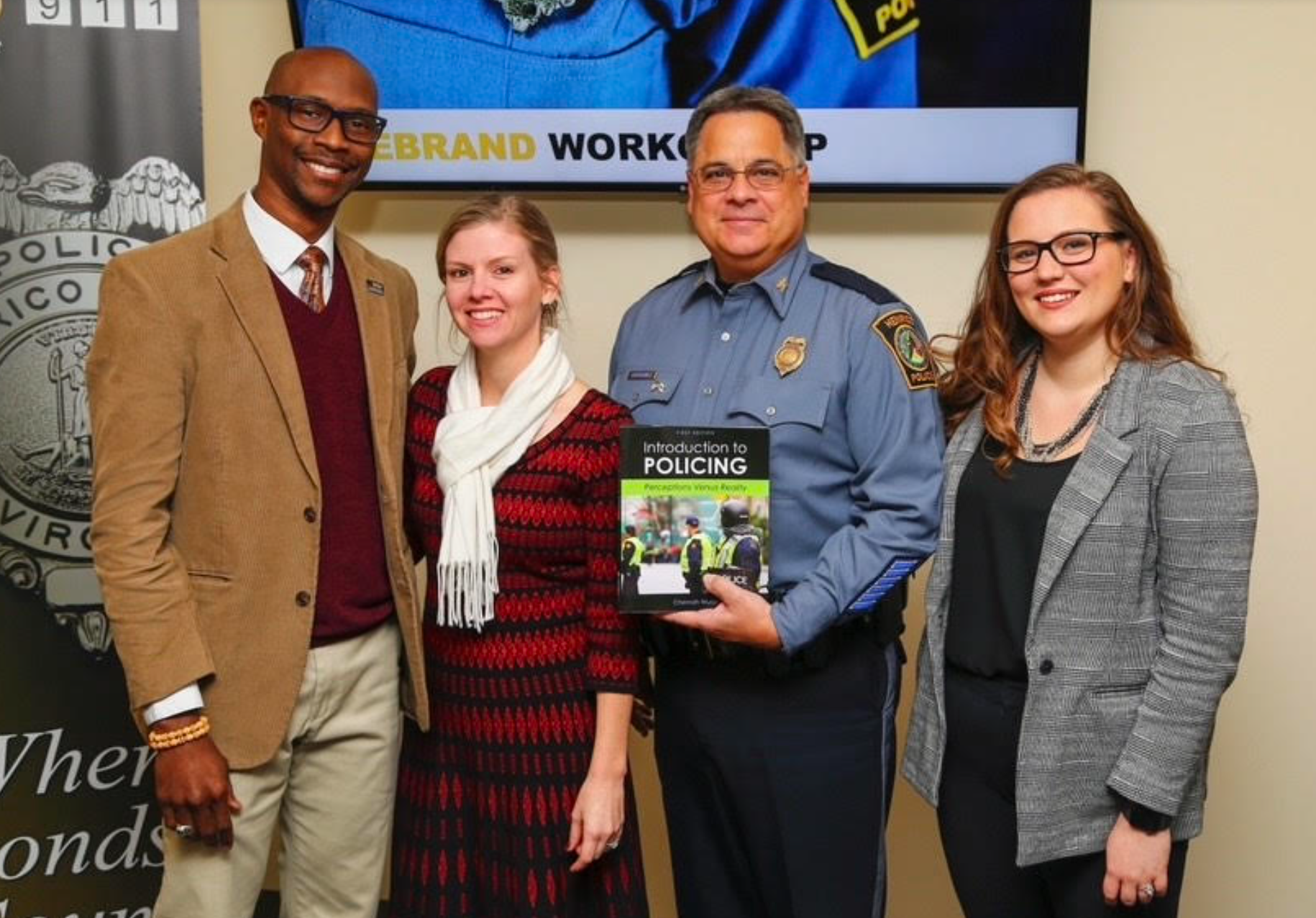 Amy Clifton-Mills (far right) created the premade quizzes that were included in Chernoh Wurie's textbook “Introduction to Policing.” Together with Wurie’s wife Jennifer, they presented the book to then Henrico Police Chief Humberto Cardounel Jr.