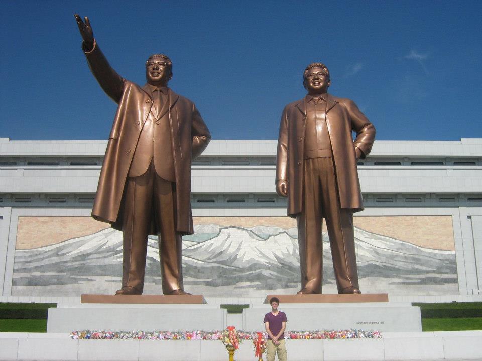Benjamin Young had a rare chance to visit North Korea in 2012. He stands with statues of statues of country leaders Kim Il-Sung on the left and Kim Jong-Il on the right.