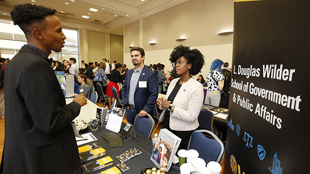 VCU Wilder School staff members Ross Losapio and Ashley Harrison greet students at the 2019 PPIA Public Sector Expo in Washington, D.C. on July 14. 
