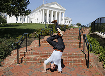 Victor Yau, a particpant in the VCU Wilder School's Public Service Weekend and a former competittive hip-hop dancer, shows off his breakdancing skills while awaiting a tour of the Virginia State Capitol. 