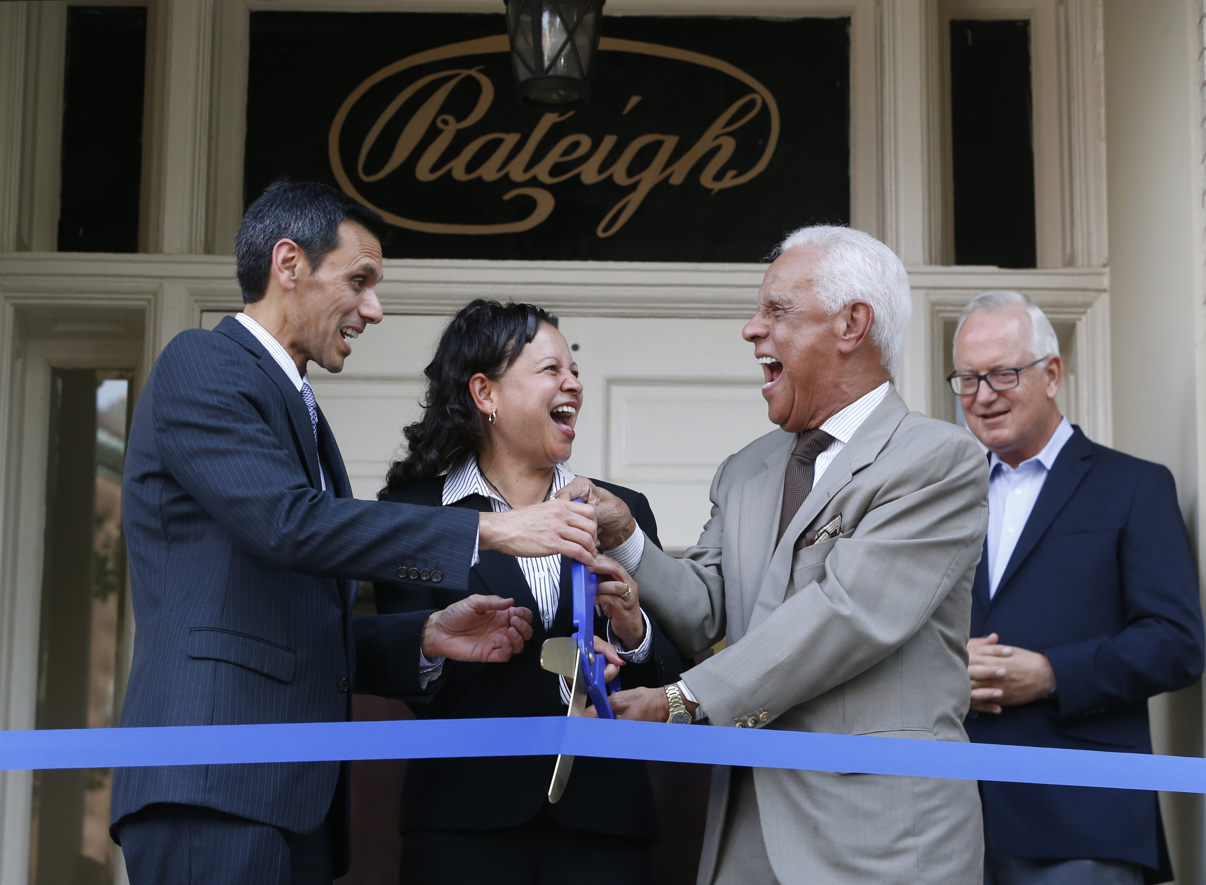VCU President Michael Rao, Ph.D., Interim Dean Susan Gooden, Ph.D., Governor L. Douglas Wilder, and Robert Holsworth, Ph.D., member of VCU's Board of Visitors, formally cut the ribbon to officially mark the opening of the Raleigh Building.